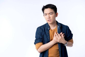 close-up-young-asian-male-businessman-casual-costume-hand-touch-heart-with-stroke-heart-attack-with-gesture-action-express-ill-sickness-bad-health-ideas-concept-white-background
